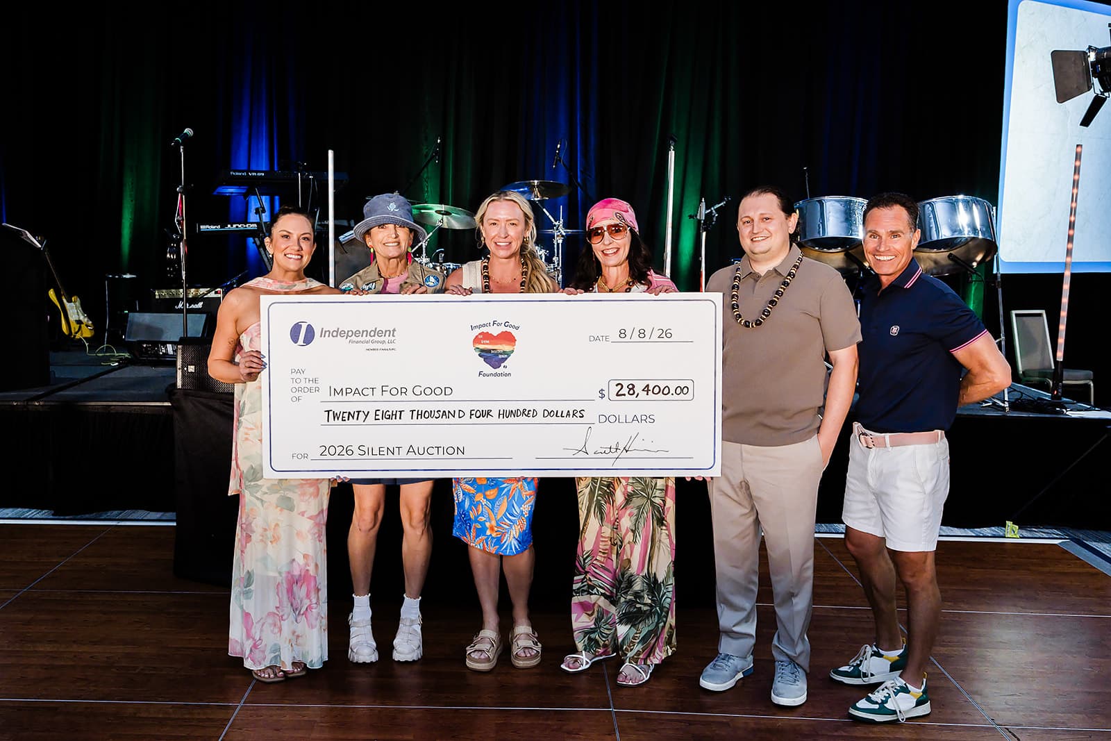 Members of Impact For Good Presenting the Charitable Contribution Check